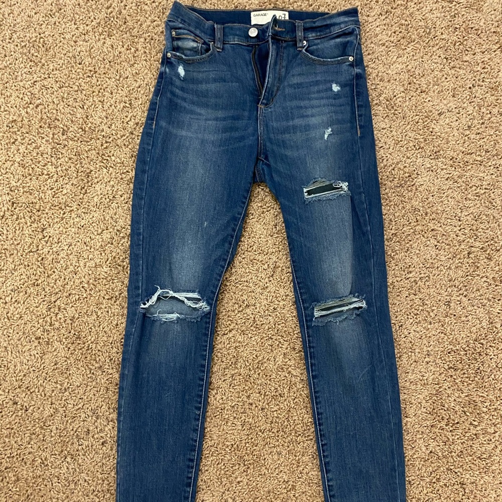 Ripped high rise blue jeans